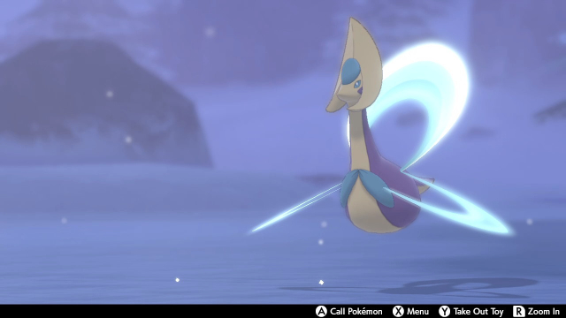 Screenshot of Cresselia roaming around the Crown Tundra's snowy landscape. Surrounding her is a soft blue glow.